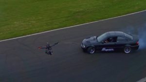 A drone being used to capture footage of a car racing on a track