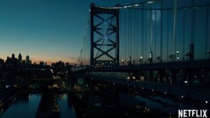 A bridge shown at twilight, photographed by a drone